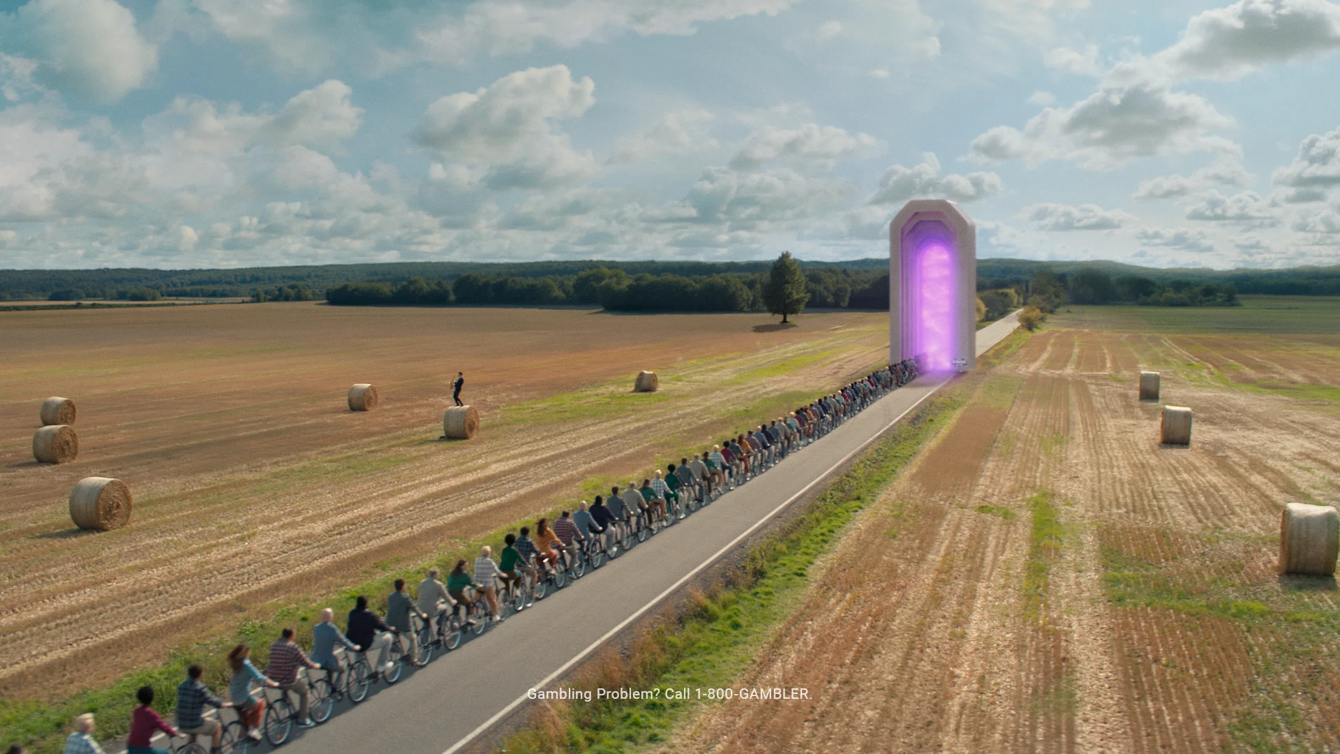 Wide shot of a crowd of people on an infinitely long tandem entering a magical portal through a marble archway.