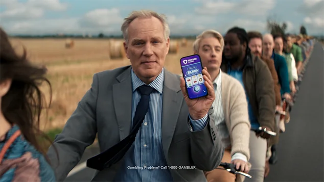 A man on an the tandem shows his phone's screen to camera.