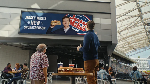 Danielle Brooks' arms start stretching as she reaches up.